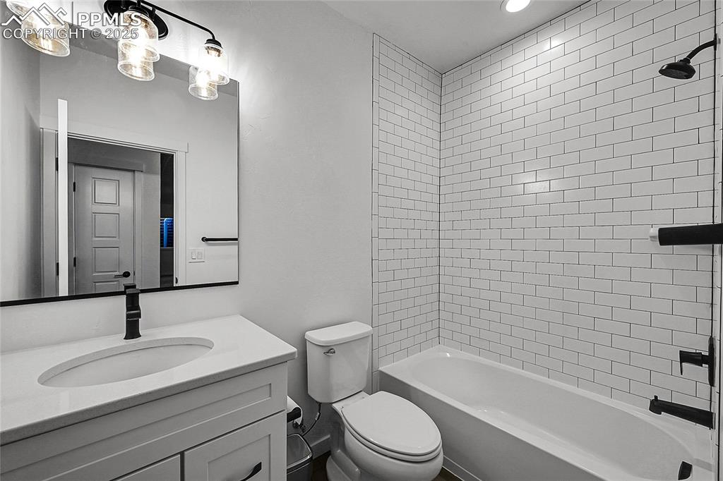 Image 26 of 29: Full bath featuring shower / bathtub combination, vanity, and recessed ligh