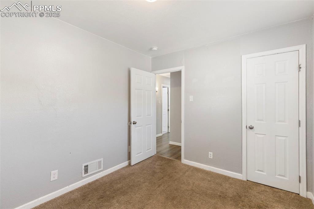 Image 11 of 25: Room with baseboards and carpet
