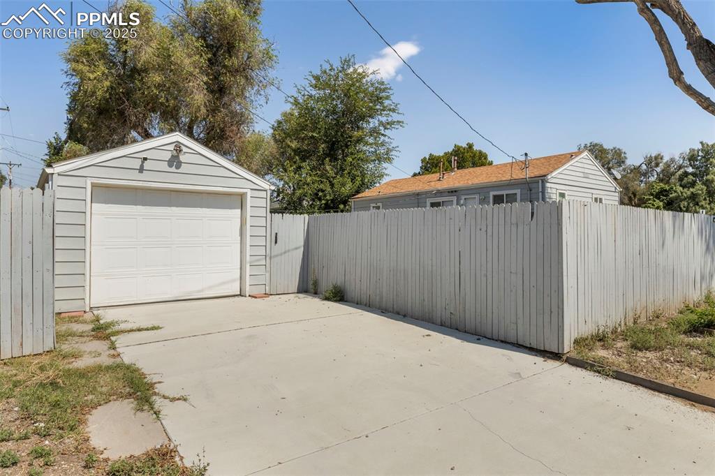 Image 25 of 25: Detached garage featuring driveway