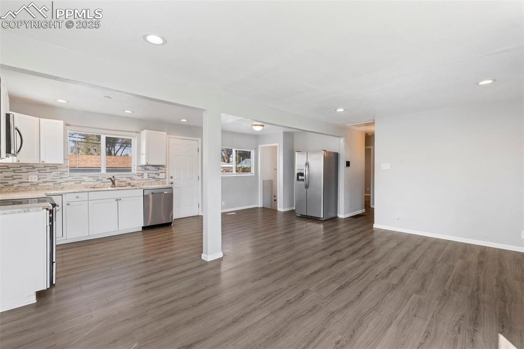 Image 4 of 25: Unfurnished living room featuring plenty of natural light, recessed lightin
