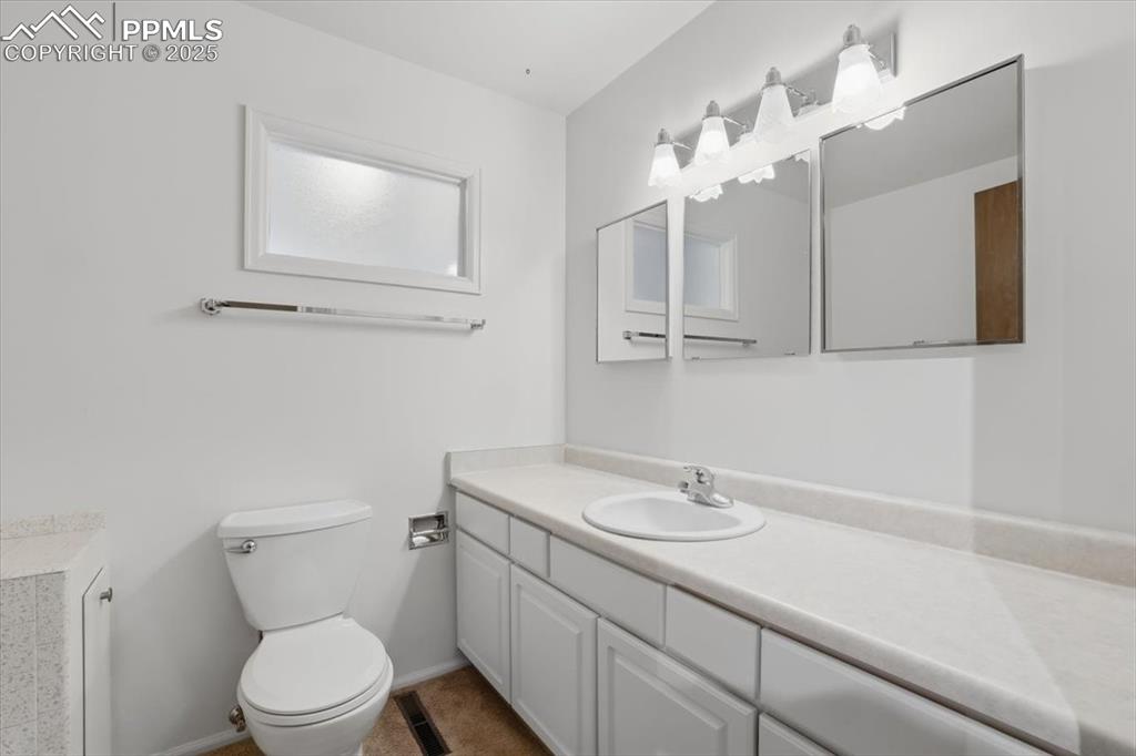 Image 21 of 50: Bathroom featuring vanity and toilet