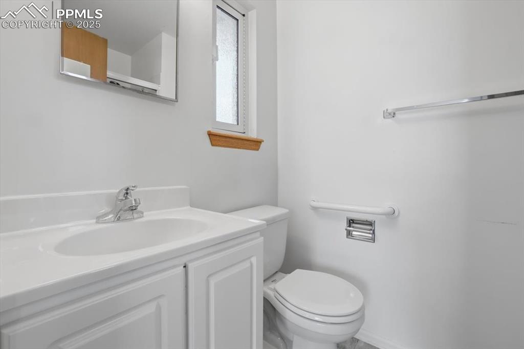 Image 24 of 50: Bathroom with vanity and toilet