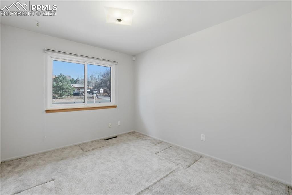 Image 25 of 50: Spare room featuring carpet floors and baseboards