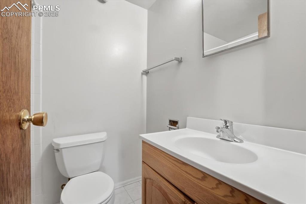 Image 39 of 50: Bathroom featuring vanity and light tile patterned floors
