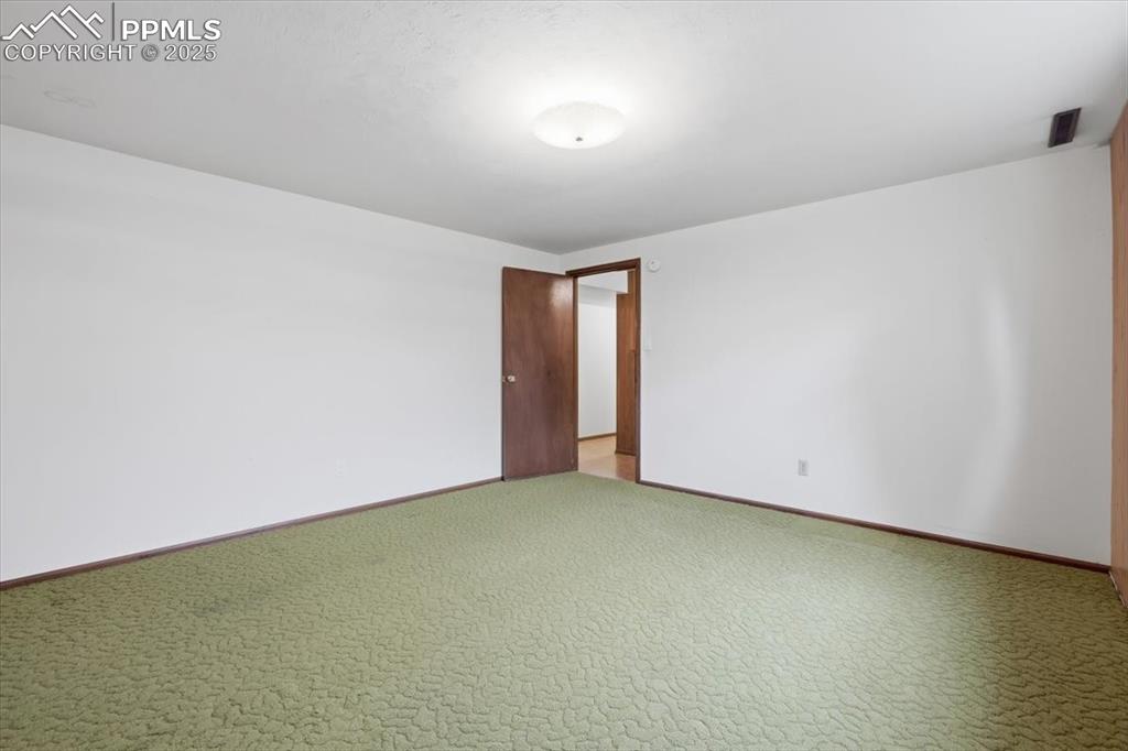 Image 43 of 50: Carpeted spare room featuring baseboards