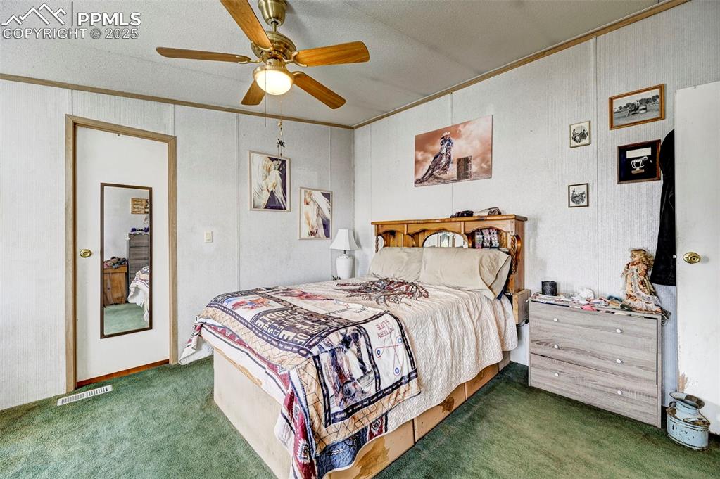 Image 12 of 44: Bedroom featuring carpet flooring, ornamental molding, and ceiling fan