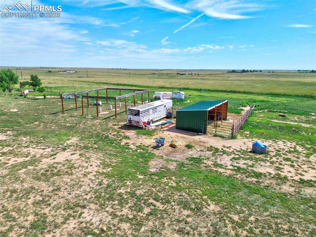 Image 26 of 44: View of yard with a rural view, an outbuilding, and an exterior structure