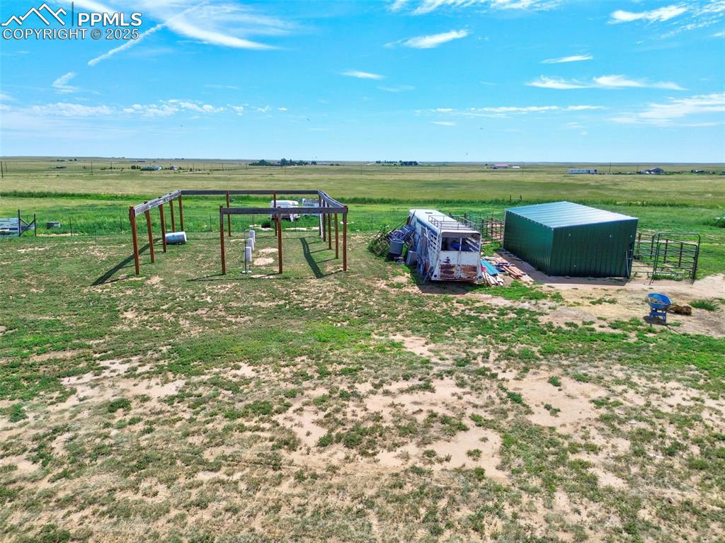 Image 27 of 44: View of yard featuring a rural view, an outbuilding, and a pole building
