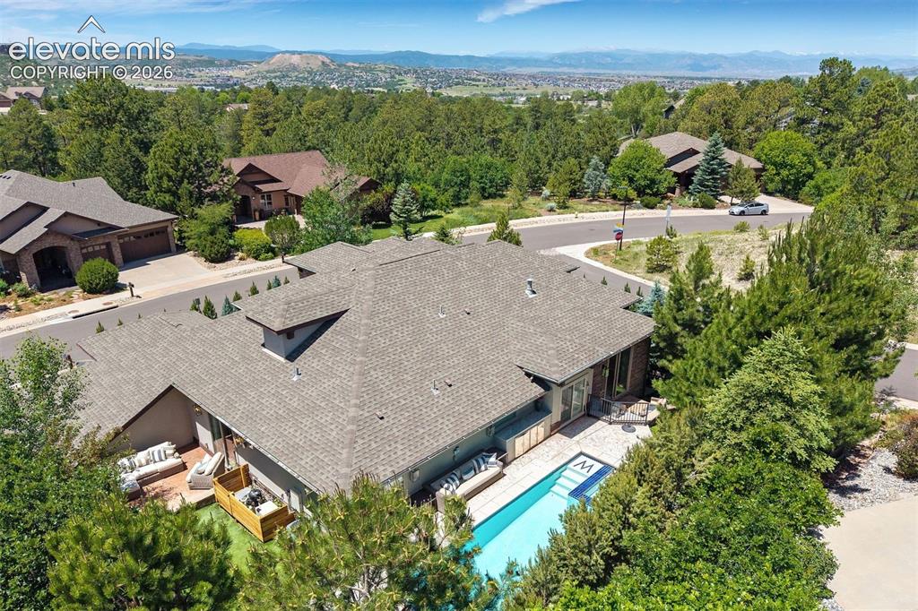 Image 2 of 49: Property featuring a gabled roof, a private swimming pool, and a paved pati