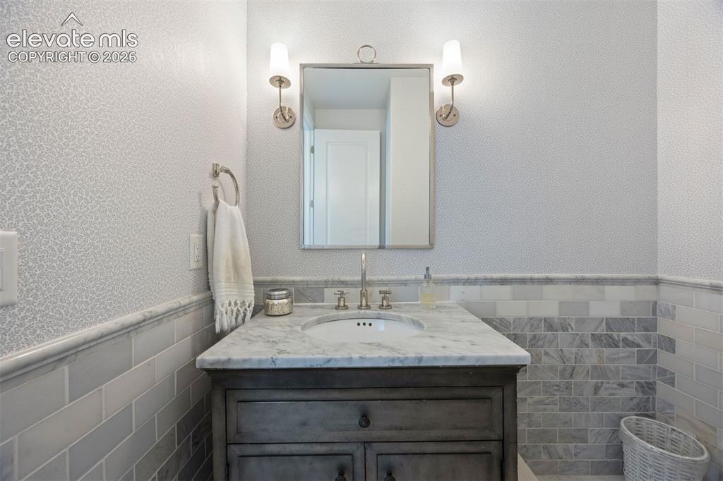 Image 33 of 49: Bathroom vanity featuring a light-toned countertop, under-mount sink, and d