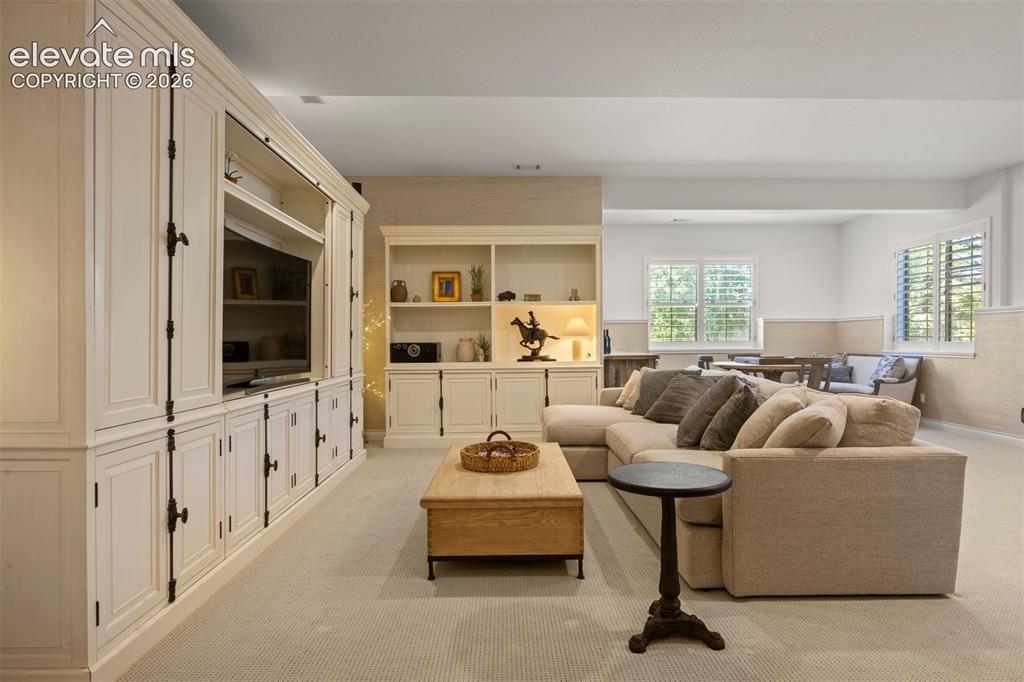 Image 35 of 49: Expansive living area featuring extensive built-in cabinetry, recessed ligh