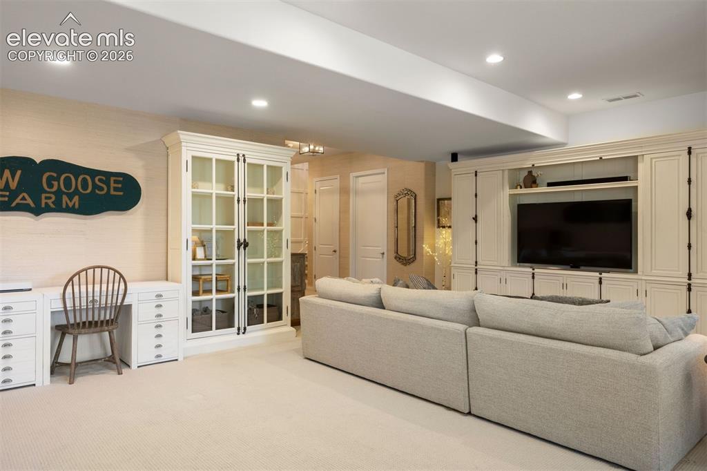 Image 39 of 49: Integrated entertainment center with custom cabinetry, recessed lighting, b