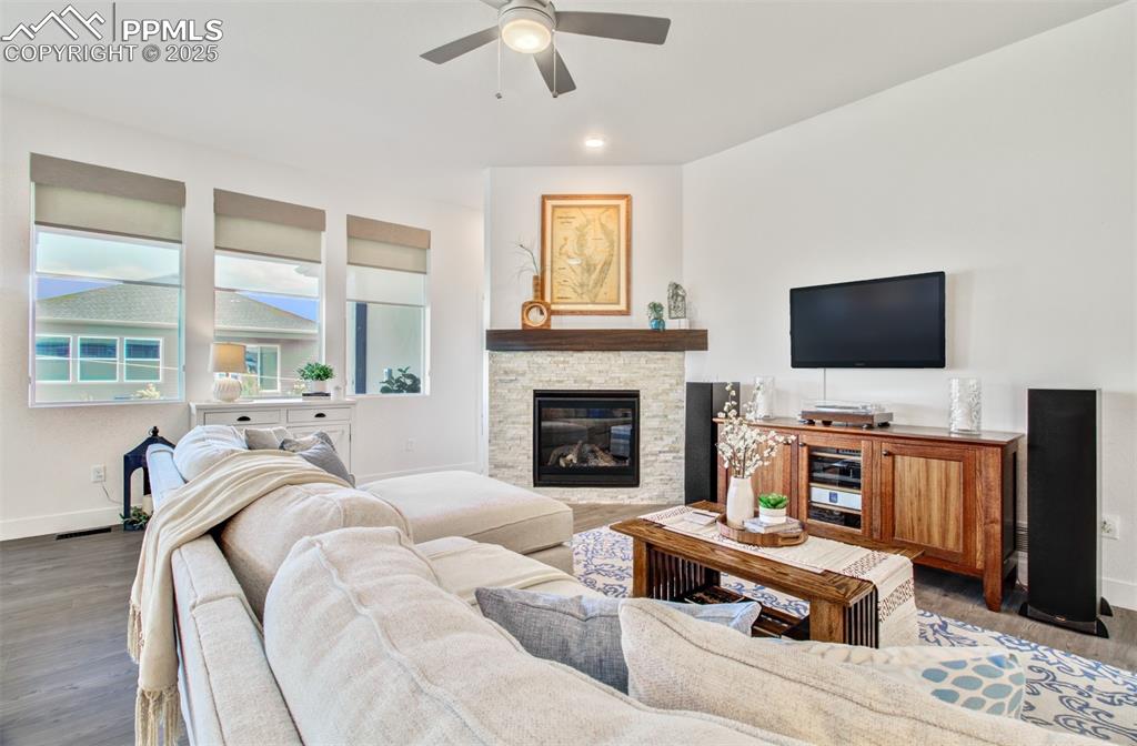 Image 6 of 48: Great room features a stone gas fireplace