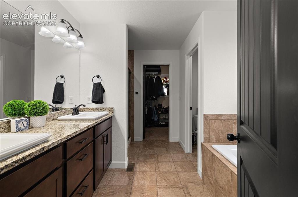 Image 15 of 39: Dual vanity with granite countertops and integrated sinks