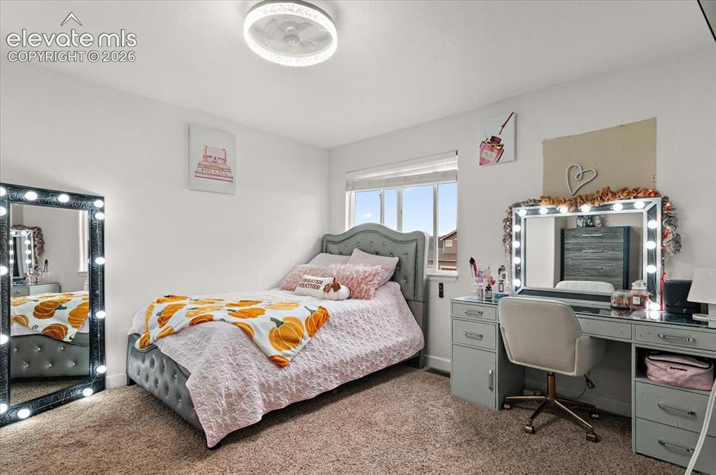 Image 20 of 39: Carpeted room featuring a window with blinds, a built-in light fixture, and