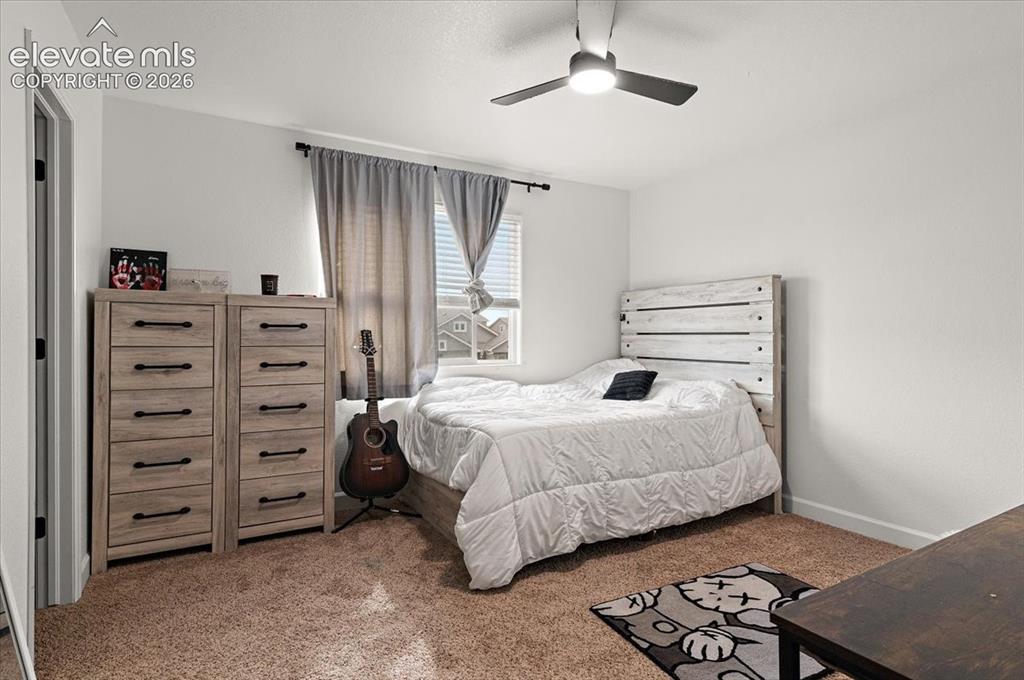 Image 21 of 39: Recessed window with blinds, ceiling fan with integrated lighting, wall-to-