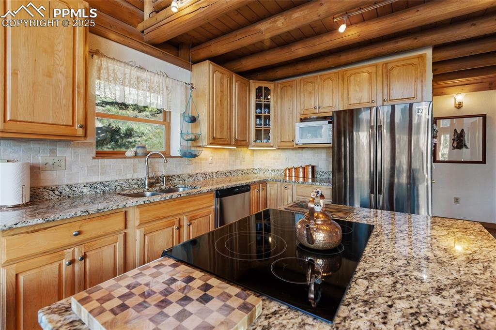 Image 10 of 34: Open and bright with granite counters and stainless appliances
