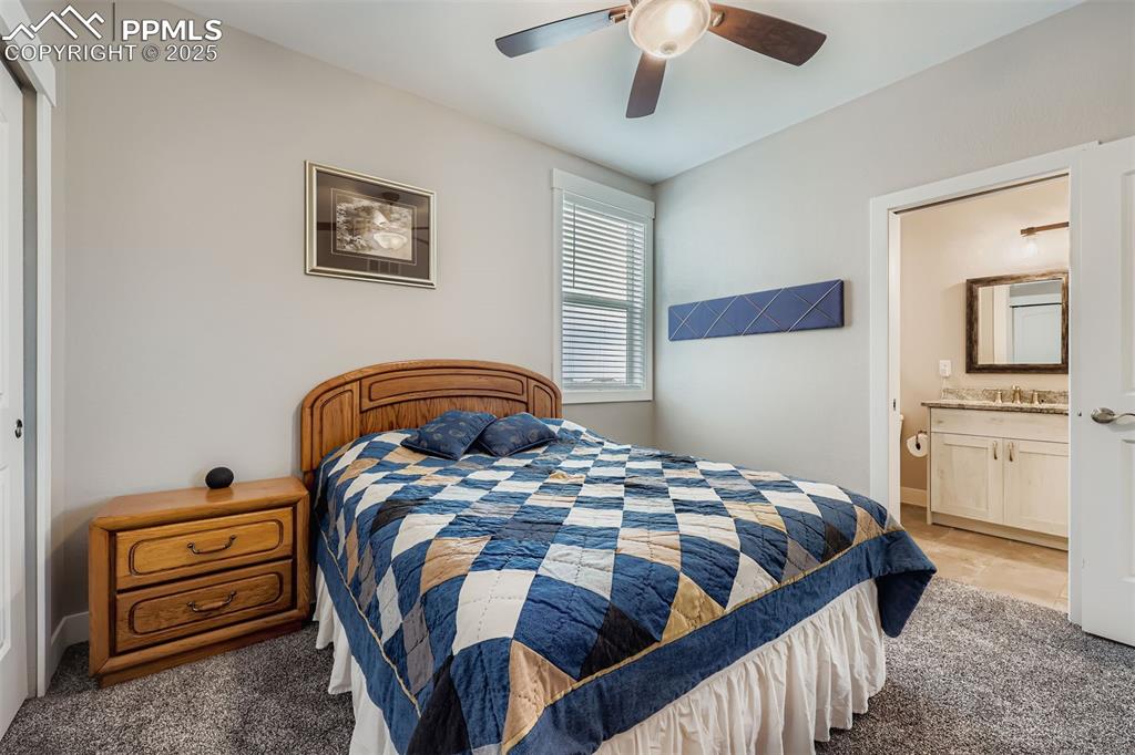 Image 18 of 42: Upper-level bedroom features adjoining full bath