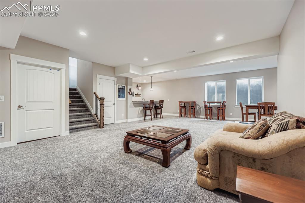 Image 25 of 42: Basement family room also includes unfinished storage, and secure basement 