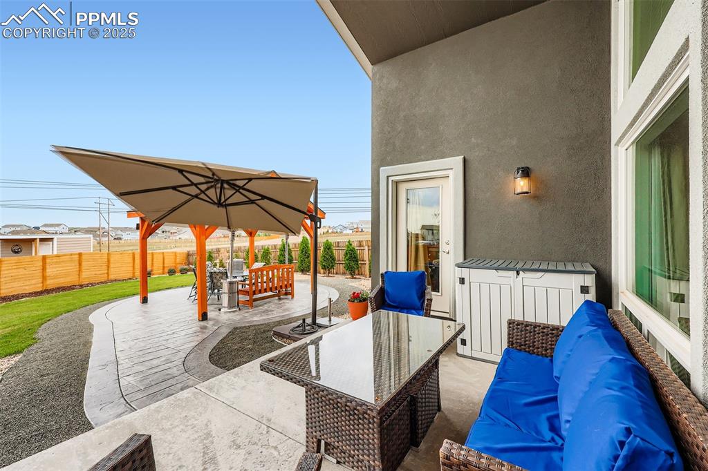 Image 37 of 42: Outside, the fully fenced backyard is a private haven with two covered pati