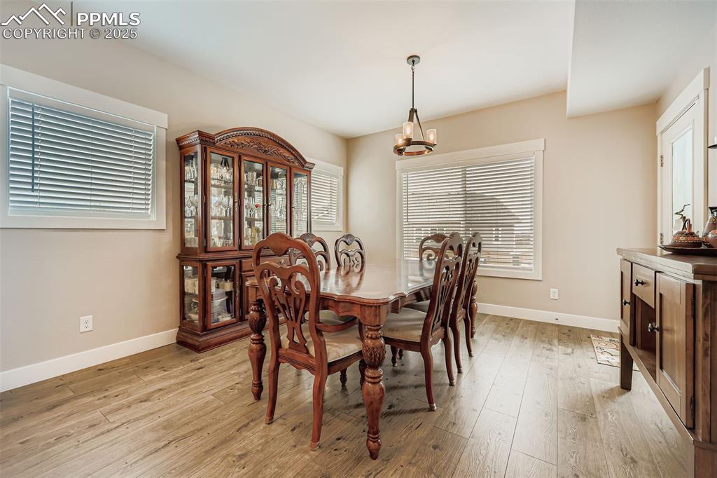 Image 6 of 42: Perfect for entertaining this dining area walks out to the covered patio an