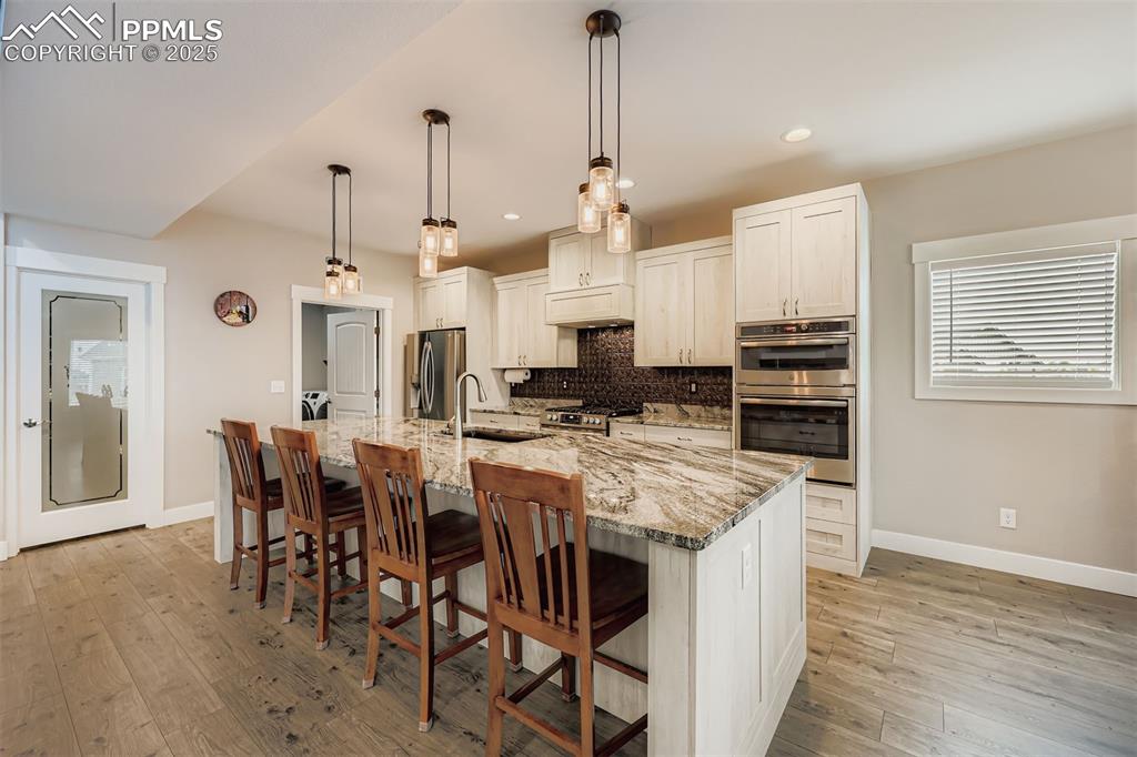 Image 7 of 42: A gourmet kitchen with sleek countertops, stainless steel appliances, and a