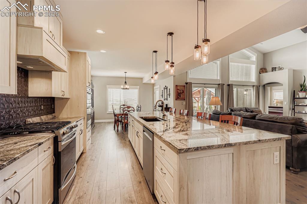 Image 9 of 42: Wall ovens and large island with breakfast counter are a plus. 