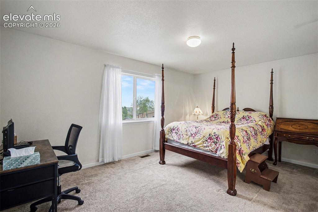 Image 12 of 33: Carpeted interior space featuring a window with natural light, white walls,