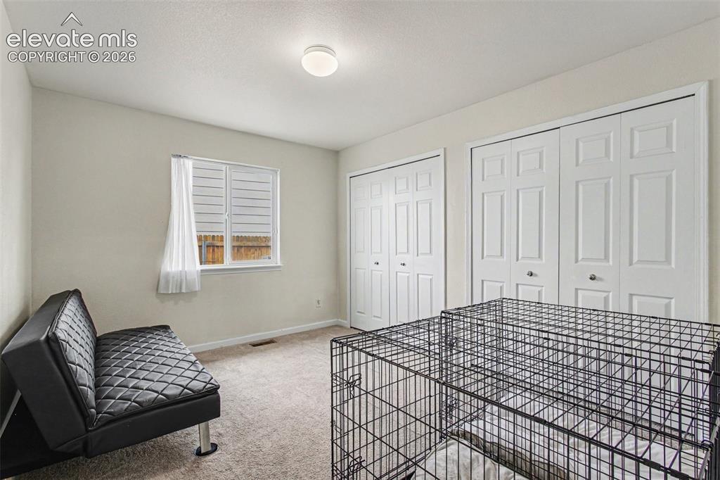 Image 14 of 33: Room featuring a single window with blinds and sheer curtain, wall-to-wall 