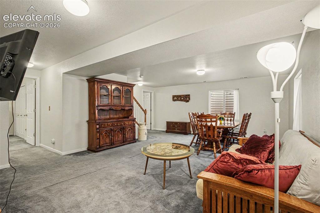 Image 19 of 33: Spacious room featuring gray carpeting, recessed ceiling lighting, and whit