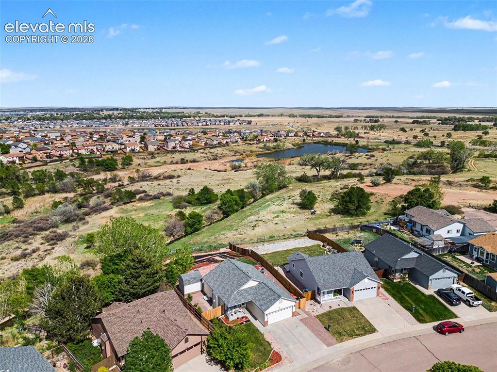 Image 31 of 33: Aerial perspective showcasing a residential community against a natural lan