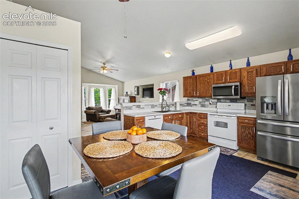Image 8 of 33: Kitchen featuring wood-finish cabinetry, stainless steel refrigerator, buil