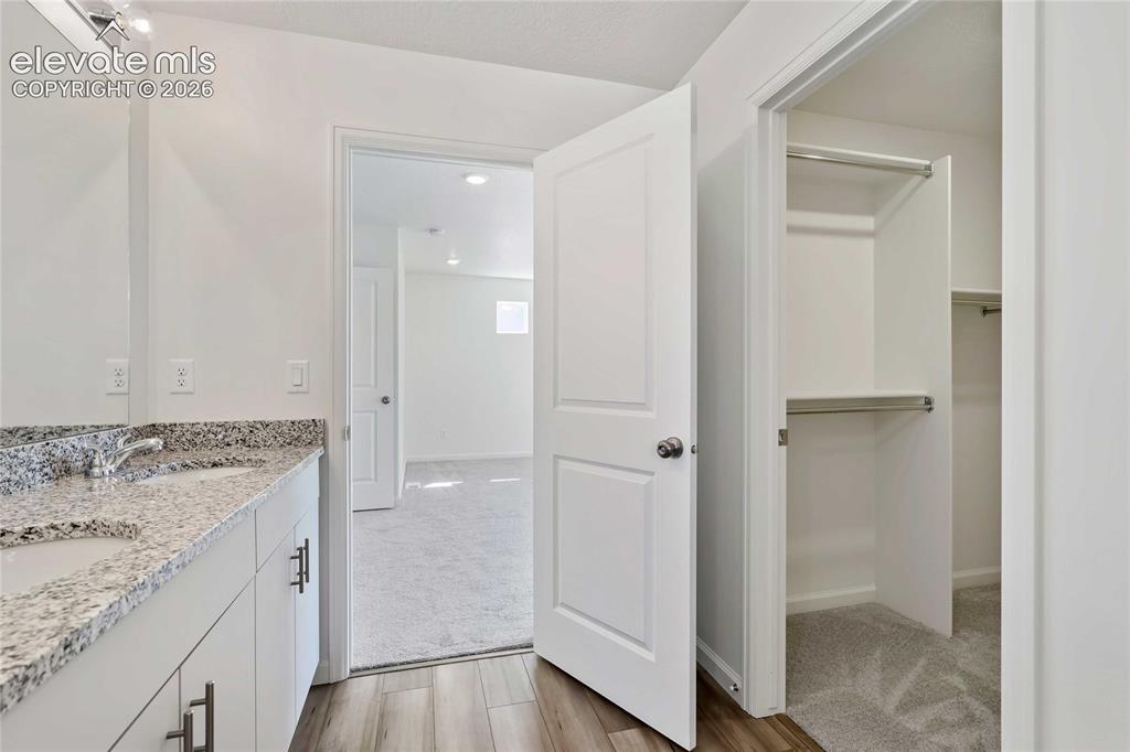 Image 11 of 25: Dual vanity with integrated sinks and granite-style countertop
*photos of