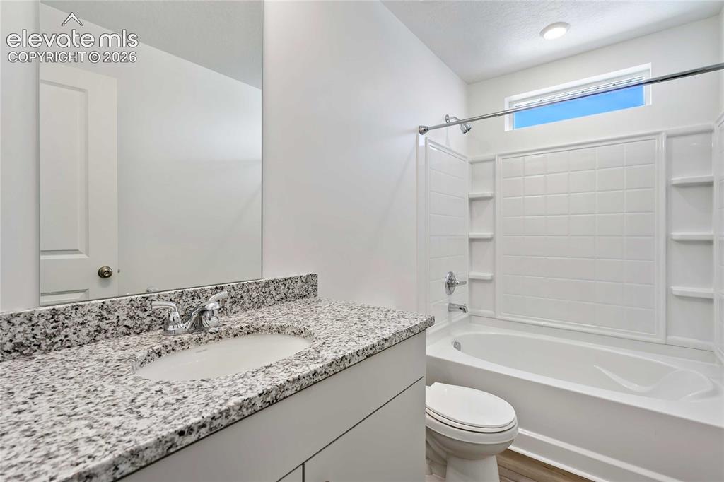 Image 18 of 25: White vanity with granite-finish countertop and integrated sink
*photos of