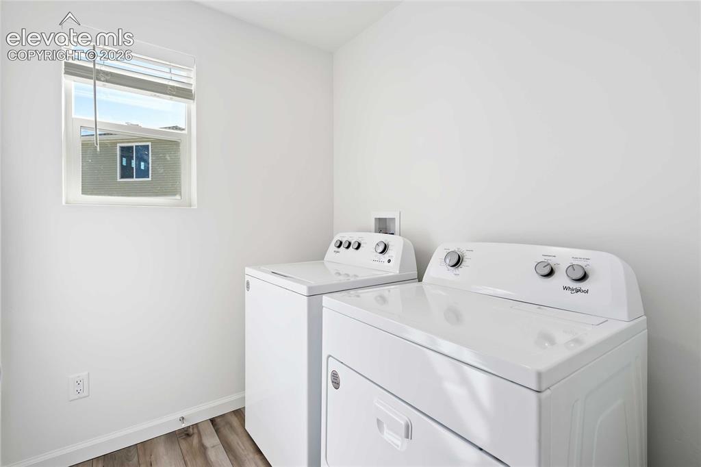 Image 9 of 25: Bright utility space with wood-finish flooring and a window
*photos of a m