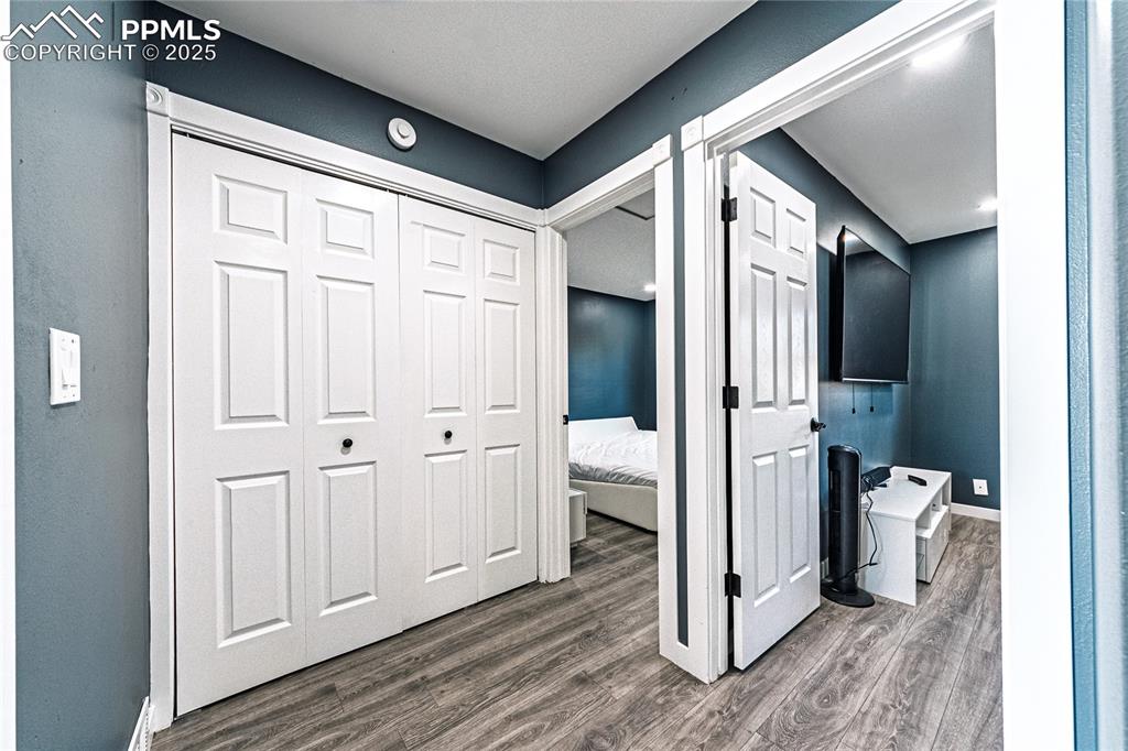 Image 18 of 46: Hallway featuring dark wood-style flooring and baseboards