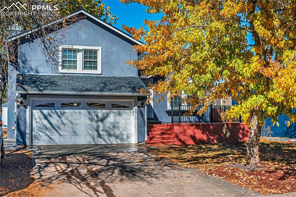 Image 2 of 46: Traditional-style home with concrete driveway, stucco siding, a garage, and