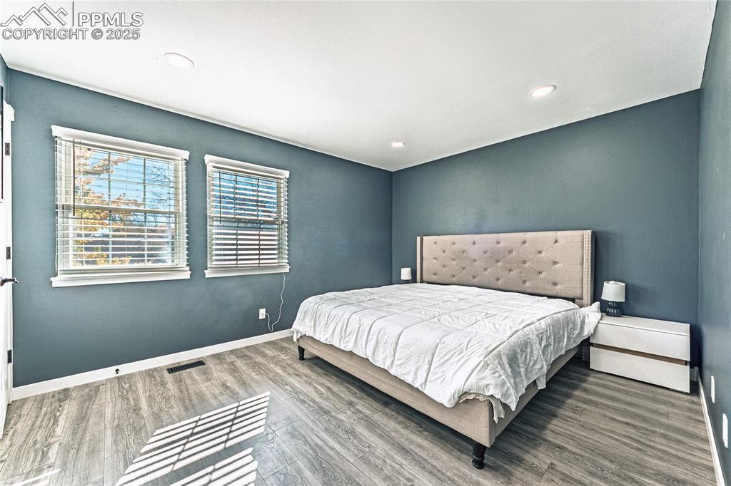 Image 21 of 46: Bedroom featuring wood finished floors and recessed lighting