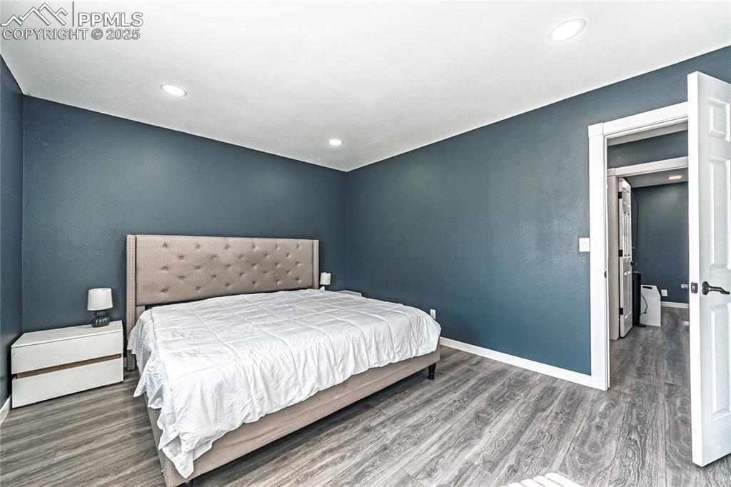 Image 22 of 46: Bedroom featuring wood finished floors and recessed lighting