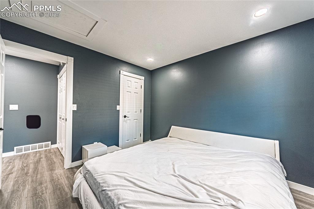Image 25 of 46: Bedroom with light wood-style floors, a closet, and recessed lighting