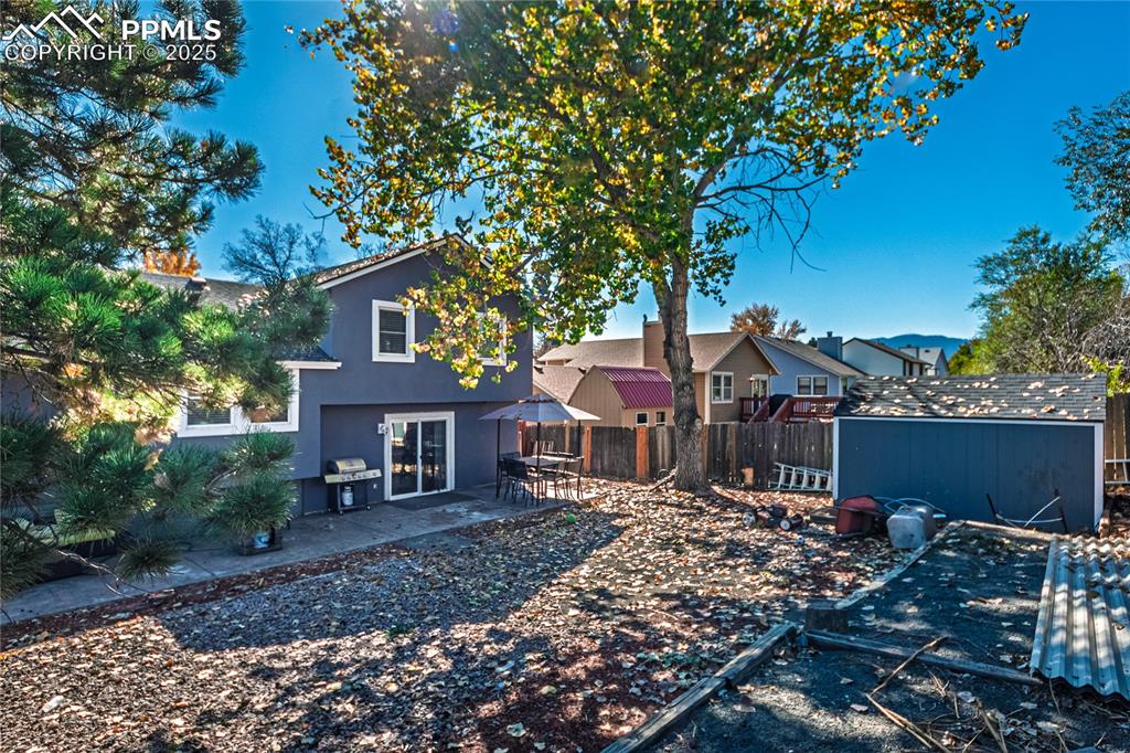 Image 32 of 46: Back of property featuring a patio, stucco siding, a fenced backyard, and a
