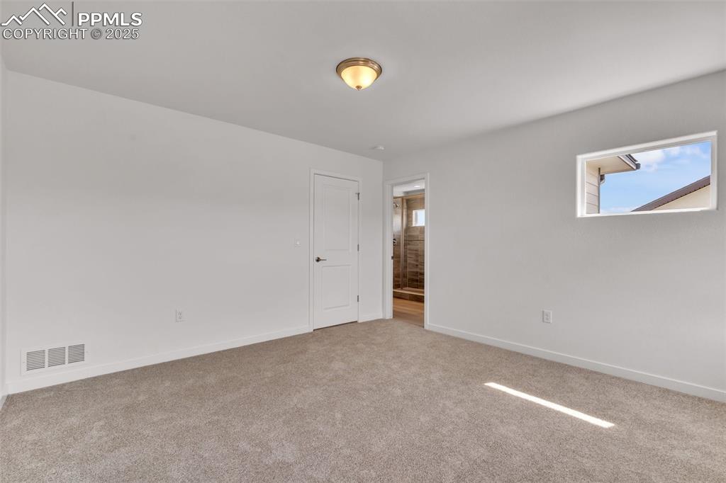 Image 10 of 43: Unfurnished room with plenty of natural light and light carpet