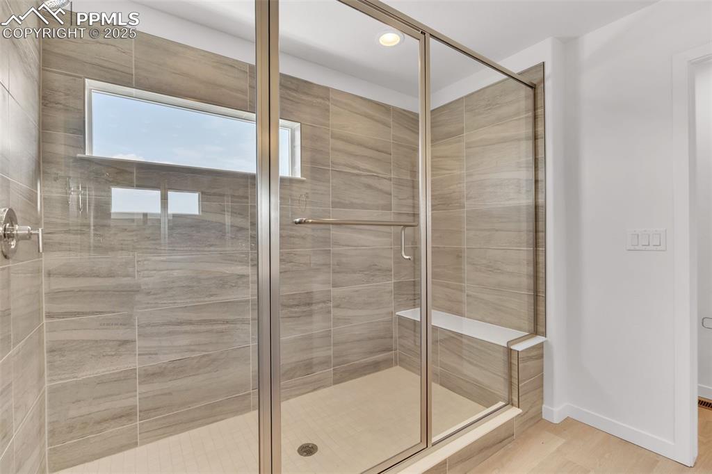 Image 14 of 43: Bathroom with a stall shower, light wood-style flooring, and recessed light