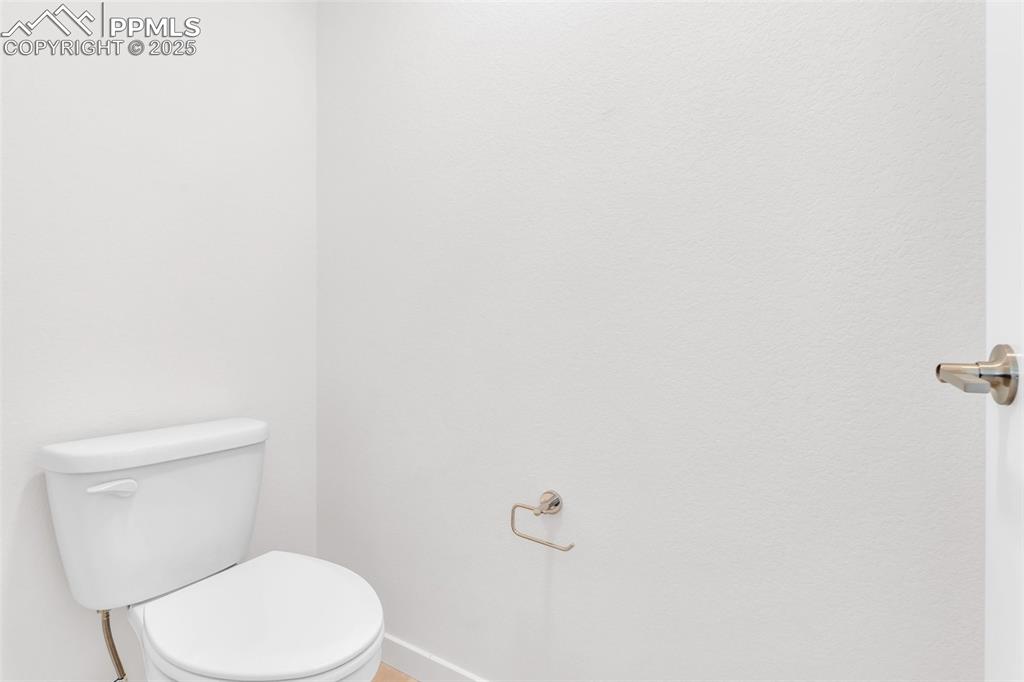Image 15 of 43: Half bathroom with toilet and baseboards