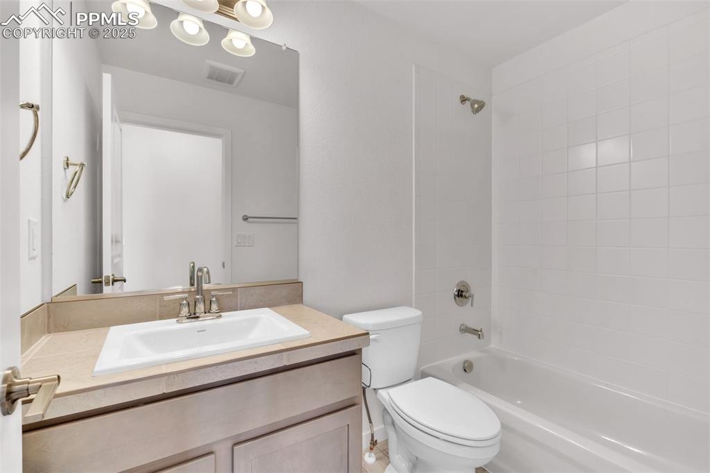Image 16 of 43: Full bathroom with washtub / shower combination and vanity