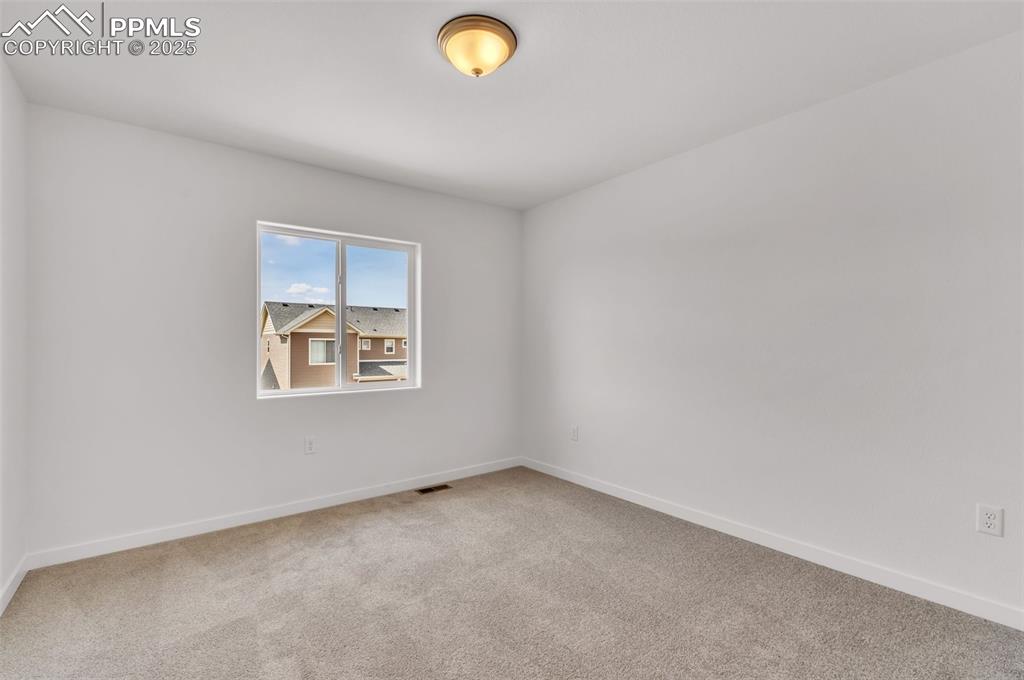 Image 17 of 43: Carpeted empty room featuring baseboards