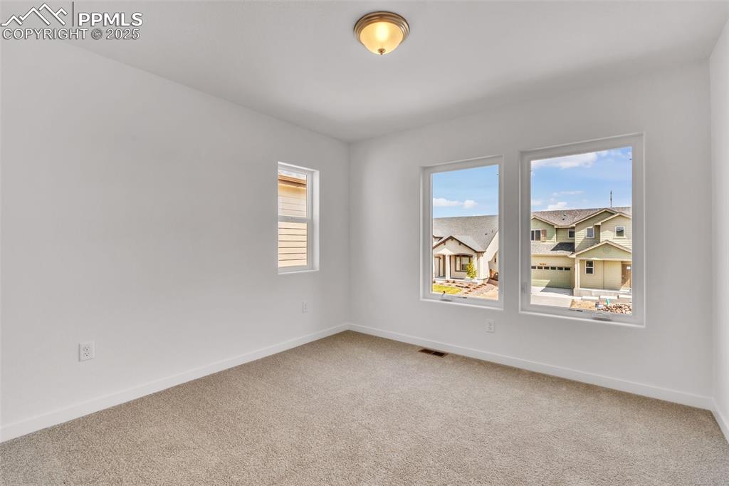Image 19 of 43: Unfurnished room with light colored carpet and baseboards