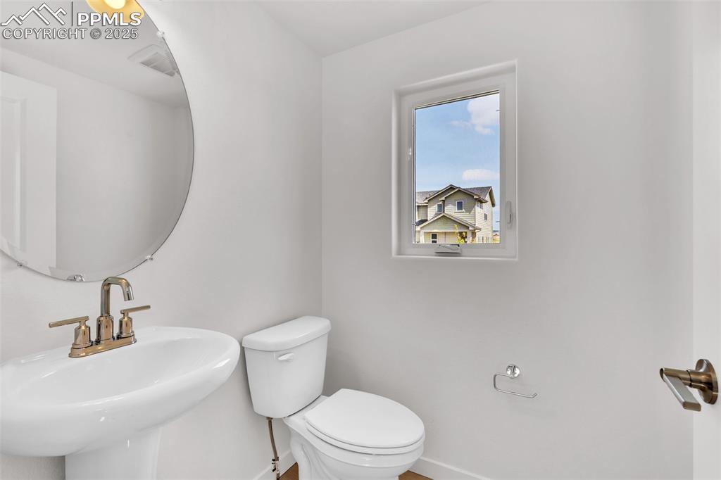 Image 21 of 43: Half bathroom featuring toilet and baseboards