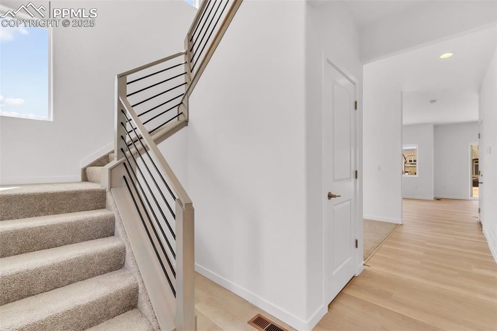 Image 22 of 43: Stairs featuring wood finished floors and recessed lighting