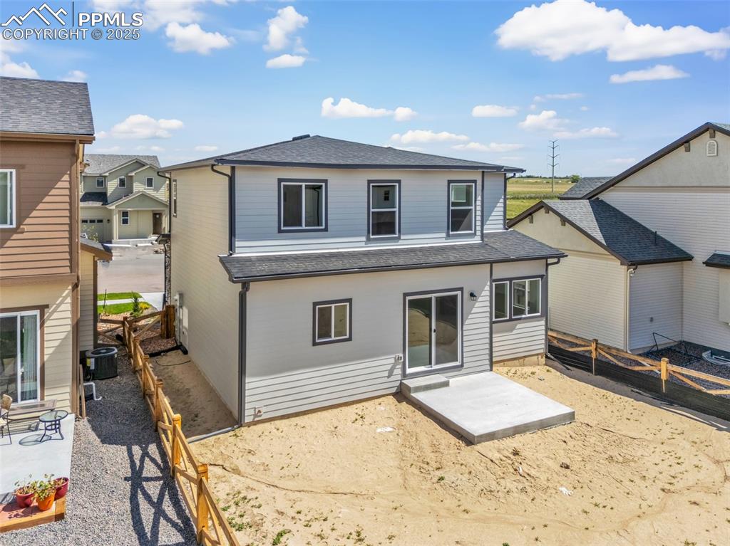 Image 41 of 43: Rear view of house with a shingled roof, a patio, and a fenced backyard